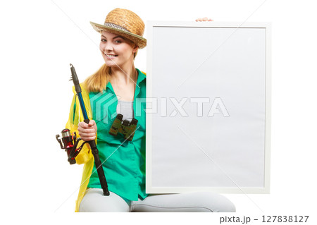Happy woman with fishing rod holding board 127838127