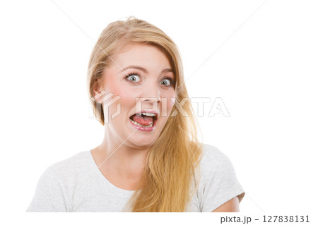Funny blonde woman sitcking tongue out 127838131