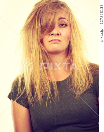 Sad blonde woman with messy hair Sad blonde woman with messy hair 127838138