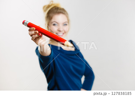 Happy woman holding giving big pencil 127838185
