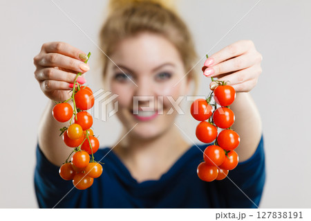 Woman holding fresh cherry tomatoes 127838191
