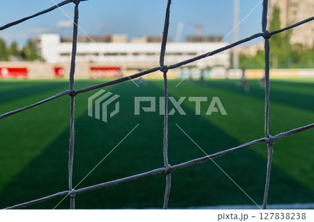 The view through a soccer goal net at a local field. High quality photo 127838238