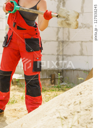 Woman using shovel on constriction site Woman using shovel on constriction site 127838245