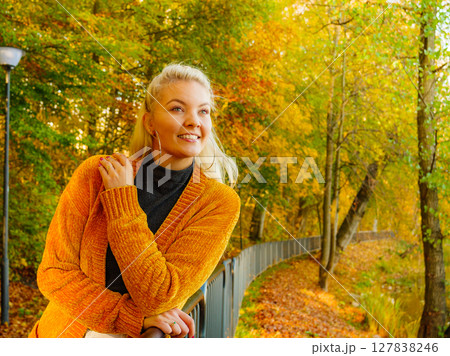 Attractive woman walking in autumn park Attractive woman walking in autumn park 127838246