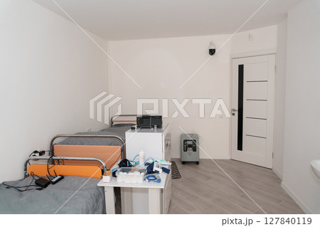 Polysomnography Room Setup with Hospital Bed, Monitoring Equipment, and White Door in a Clean, Brightly Lit Clinical Environment Polysomnography Room Setup with Hospital Bed, Monitoring Equipment, and White Door in a Clean, Brightly Lit Clinical Environment 127840119