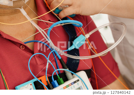 Patient Monitoring with PSG System: Chest Leads, ECG, Heart Rate Display, Medical Technology, Intensive Care, Red Shirt, Close-Up View 127840142