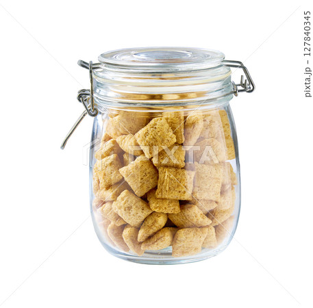glass jar with corn pillows isolated on a white background. 127840345