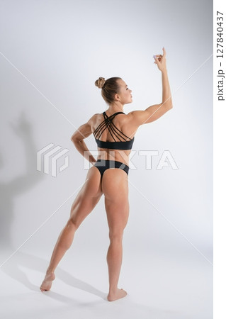 Woman showcasing fitness and strength in stylish lingerie and a dynamic pose Woman showcasing fitness and strength in stylish lingerie and a dynamic pose 127840437