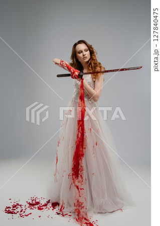 Bridal beauty with katana evokes dramatic themes of murder and vengeance 127840475