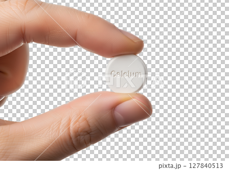 Hand holding calcium tablet isolated on transparent background, white supplement close-up 127840513