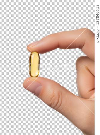 Hand holding omega-3 fish oil capsule isolated on transparent background, supplement close-up 127840515