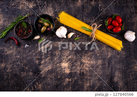 Italian food background with spaghetti, tomato and spices Italian food background with spaghetti, tomato and spices 127840566
