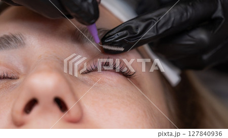 Close-up of a woman's eye after eyelash lamination procedure.  127840936