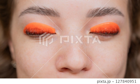 Caucasian woman undergoing eyelash lamination procedure. top view.  127840951