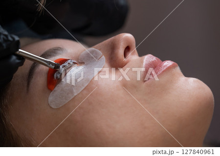 Caucasian woman undergoing eyelash lamination procedure. Caucasian woman undergoing eyelash lamination procedure. 127840961
