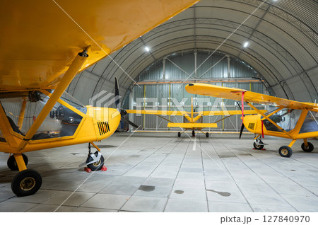 Yellow airplane glider in the hangar. Yellow airplane glider in the hangar. 127840970