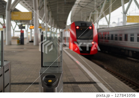 Glass turnstile at the railway station.  127841056