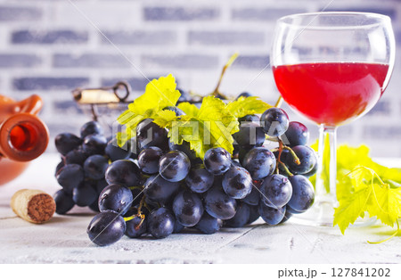 Red wine grapes on white table Red wine grapes on white table 127841202