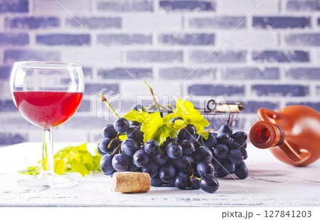 Red wine grapes on white table Red wine grapes on white table 127841203
