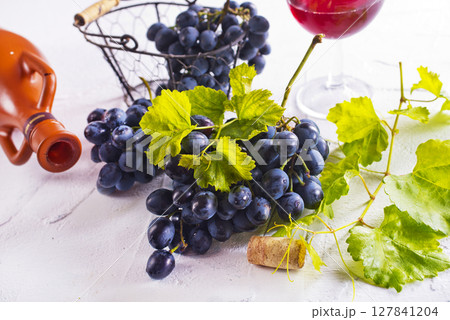 Red wine grapes on white table Red wine grapes on white table 127841204