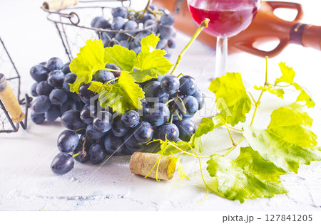 Red wine grapes on white table Red wine grapes on white table 127841205