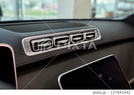 Closeup of car dashboard air vents near gear shift Closeup of car dashboard air vents near gear shift 127841442