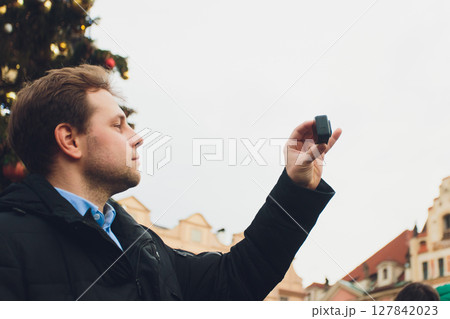 hands holding a power gold bank being and action camera 127842023