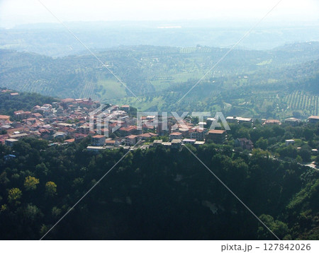 Stunning panoramic view of Vibo Valentia, a historic town nestled in the hills of Calabria, southern Italy. The scene features rolling green mountains, lush vegetation, and charming Mediterranean. Stunning panoramic view of Vibo Valentia, a historic town nestled in the hills of Calabria, southern Italy. The scene features rolling green mountains, lush vegetation, and charming Mediterranean. 127842026