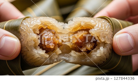 Close Up of Zongzi Traditional Chinese Sticky Rice Dumpling Split in Half Revealing Filling 127844336