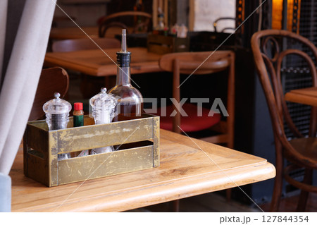 Charming Restaurant Table Setting Featuring Various Condiments and More 127844354