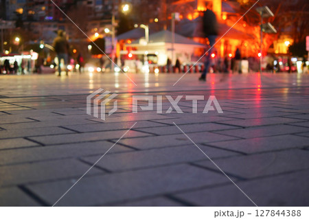 Captivating and Vibrant Reflections on Wet Pavement Under the Night Sky Captivating and Vibrant Reflections on Wet Pavement Under the Night Sky 127844388