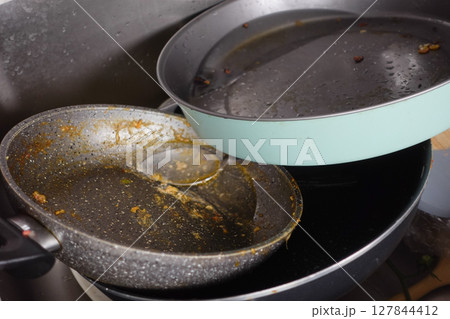 Dirty Cookware is Piling Up in the Kitchen Sink and Needs Attention Dirty Cookware is Piling Up in the Kitchen Sink and Needs Attention 127844412
