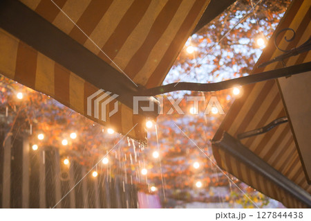 A Rainy Night in the City Filled with Lanterns and a Beautiful Orange Canopy Above A Rainy Night in the City Filled with Lanterns and a Beautiful Orange Canopy Above 127844438