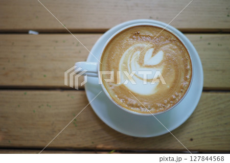 Delicious latte art served in a cozy cafe setting Delicious latte art served in a cozy cafe setting 127844568
