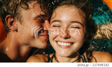 Young Couple Kissing in Swimming Pool 127846182