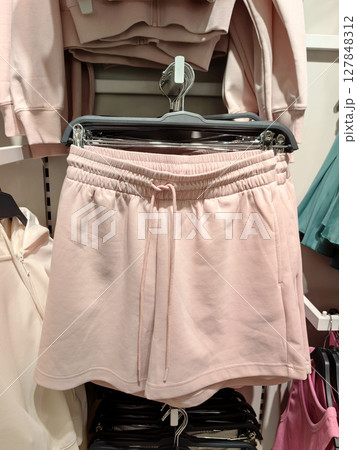soft pink shorts displayed in retail store for casual summer wear. closeup. soft pink shorts displayed in retail store for casual summer wear. closeup. 127848312