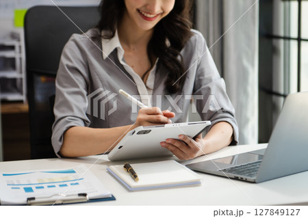business woman using laptop computer at modern office with blurred background 127849127