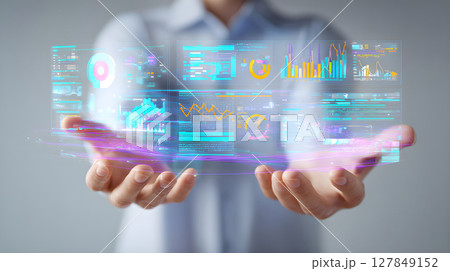 Futuristic data visualization interface in hands. Businessman holding virtual analytics dashboard. Modern AI-driven data analysis concept. Holographic big data and business intelligence tools. 127849152