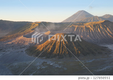 The morning view of the sun shining on Bromo volcano Indonesia in long distance. 127850551