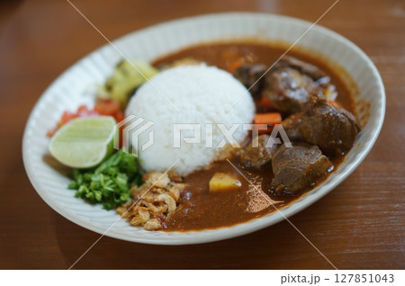 Thai pork neck in red kapok flowers curry with rice dish Thai pork neck in red kapok flowers curry with rice dish 127851043