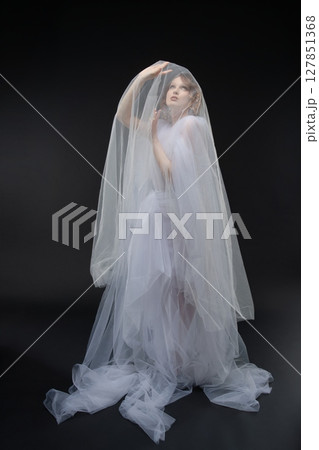 Elegant bride in a modern gown showcases beauty and grace Elegant bride in a modern gown showcases beauty and grace 127851368