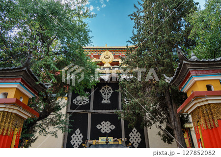 Ornate Tibetan Monastery Entrance with Dharmachakra Symbol Ornate Tibetan Monastery Entrance with Dharmachakra Symbol 127852082