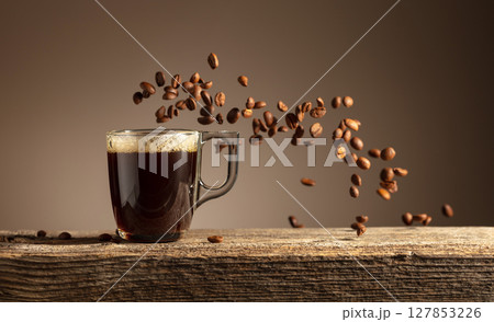Espresso in glass cup on a old wooden table. 127853226