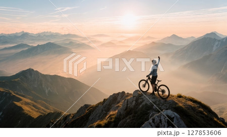 Scenic Mountain Biker on Summit, Triumph, Nature, Healthy Lifestyle. Ideal for sports brands, outdoor activities, fitness, well-being 127853606