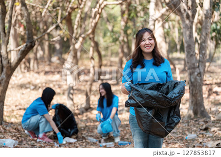 Group of Volunteers Engaging in Eco-Friendly Activities by Collecting Trash in a Forested Area to Promote Environmental Conservation and Sustainability Group of Volunteers Engaging in Eco-Friendly Activities by Collecting Trash in a Forested Area to Promote Environmental Conservation and Sustainability 127853817