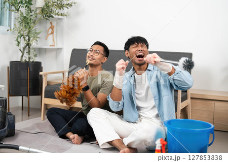 LGBTQIA Partners Singing While Cleaning Their Home 127853838