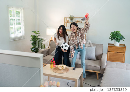 Happy football fan loudly congratulating team on winning tournament, match on tv 127853839