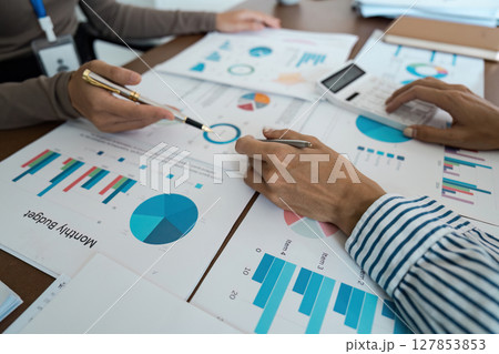 Business Team Analyzing Financial Graphs and Charts, High-Angle View Concept of financial analysis and teamwork 127853853