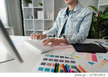Graphic or UI designer work on computer laptop and with tablet after brainstorming unique design with professional developer UX team 127853915
