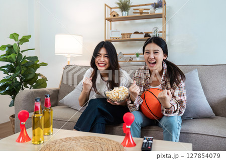 LGBT Soccer or Sport fans emotionally watching game in the living room LGBT Soccer or Sport fans emotionally watching game in the living room 127854079